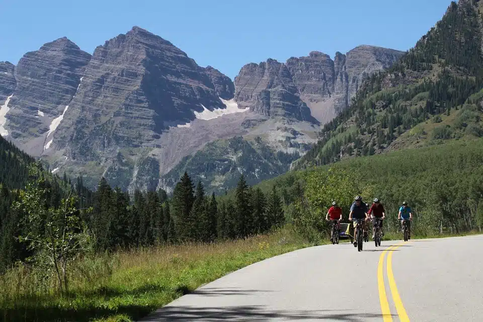 group biking by mountains