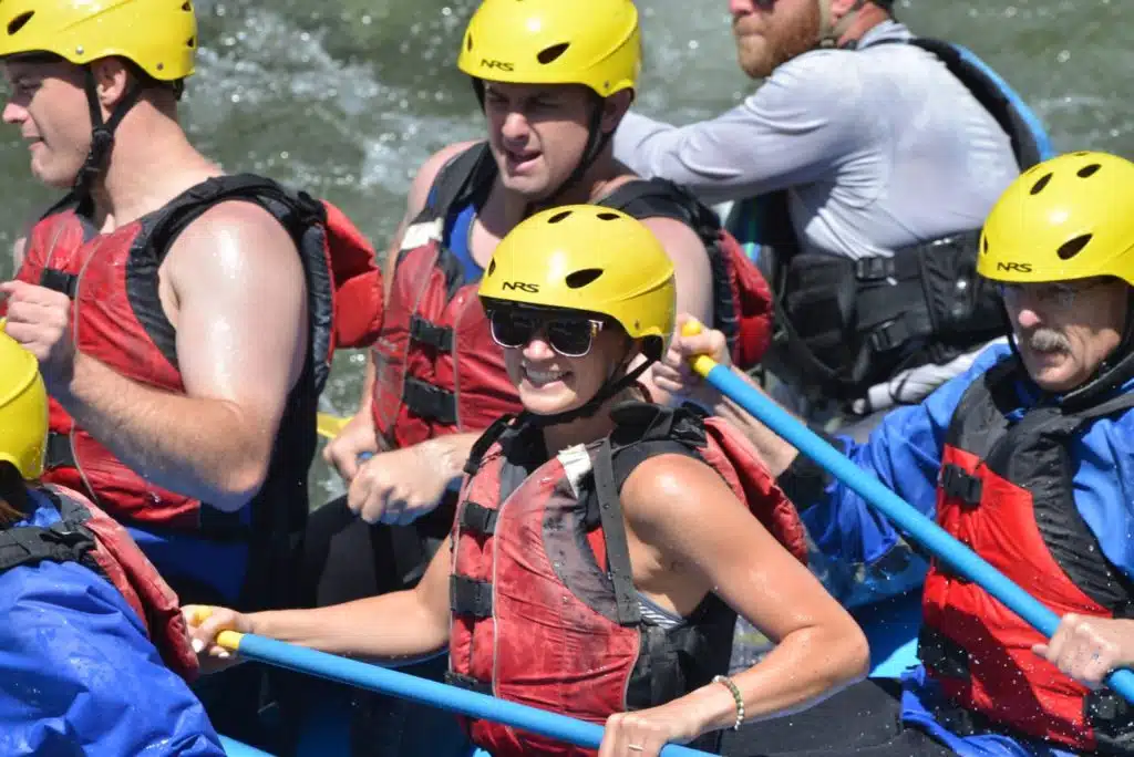 smiling with sunglasses in raft