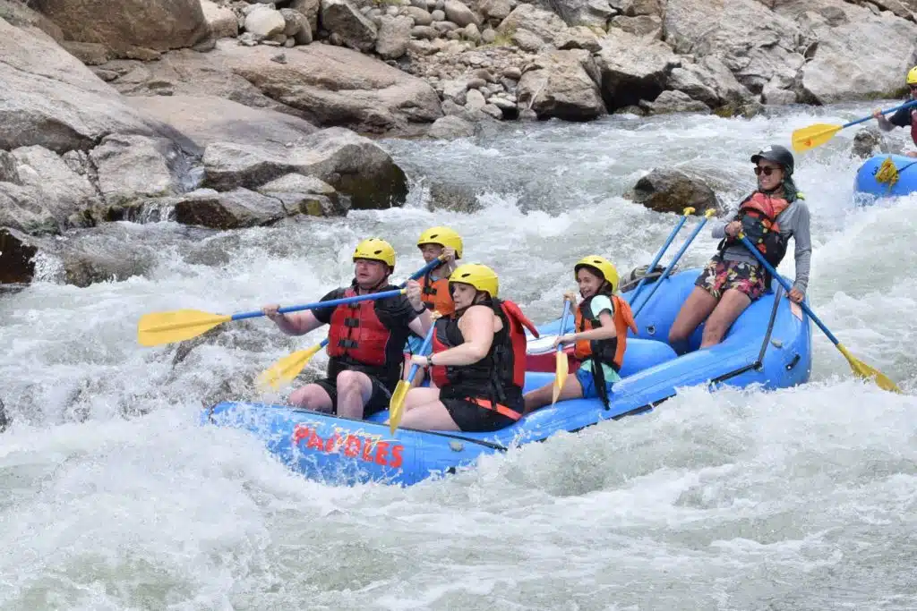 group paddling in rapids