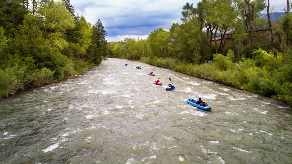 several kayaks going down river