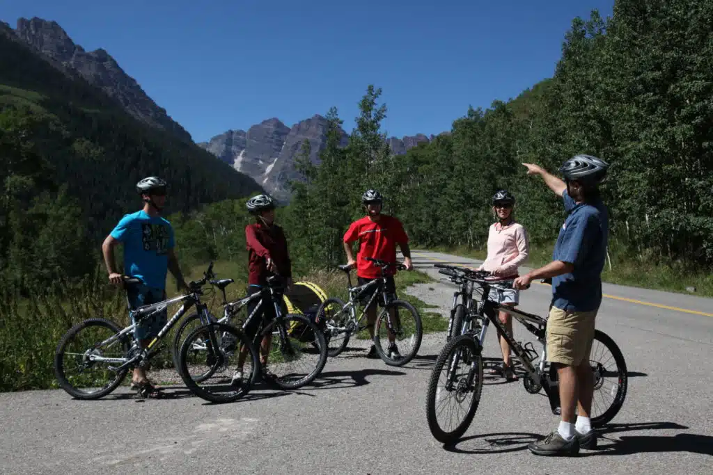 biker points at a mountain