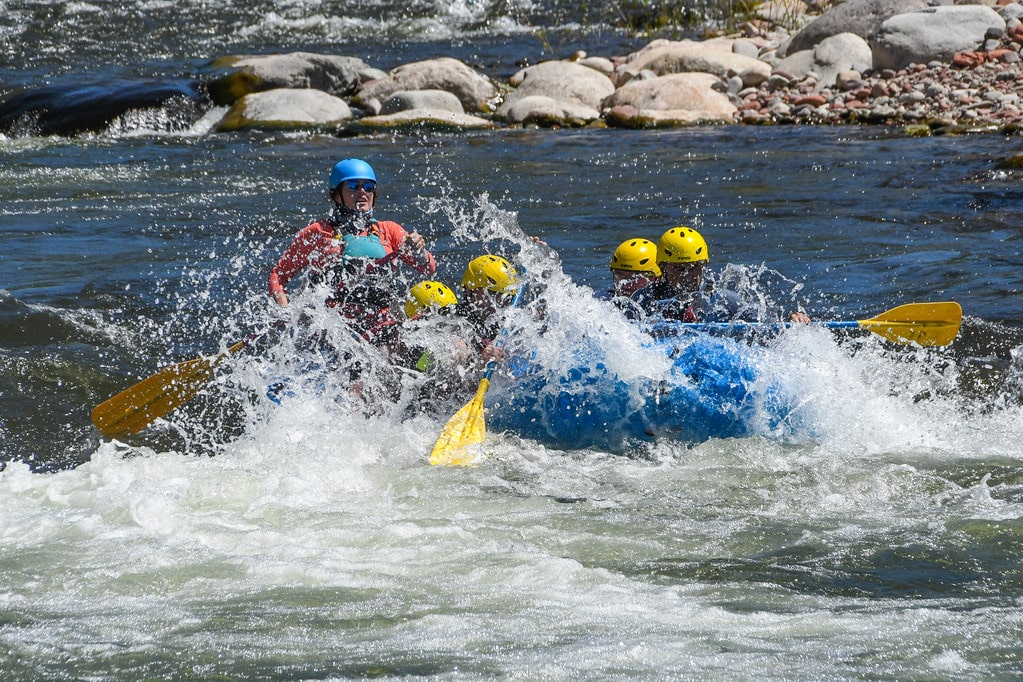 group getting splashed in raft