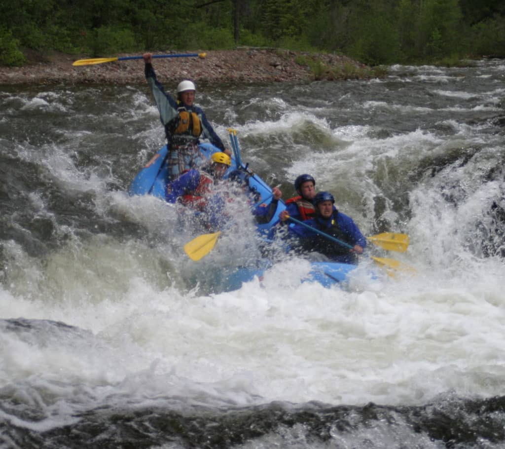 man cheers in a raft